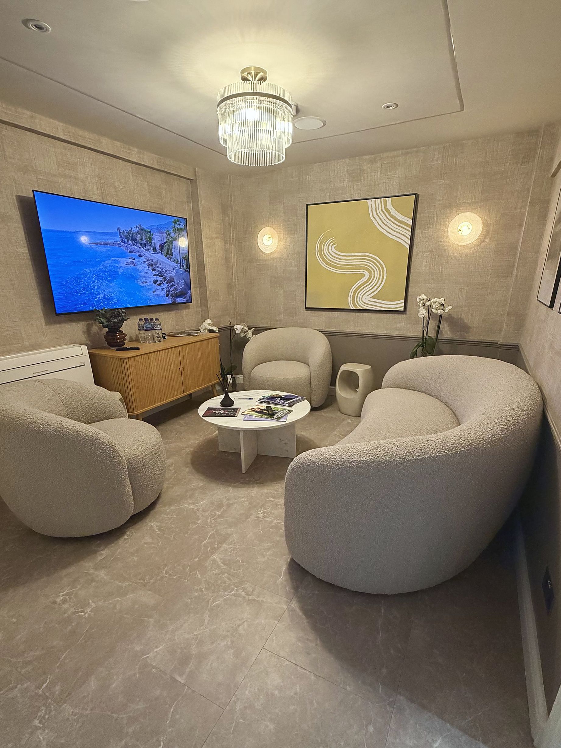 The waiting lounge at DROM Clinic, with curved boucle seating